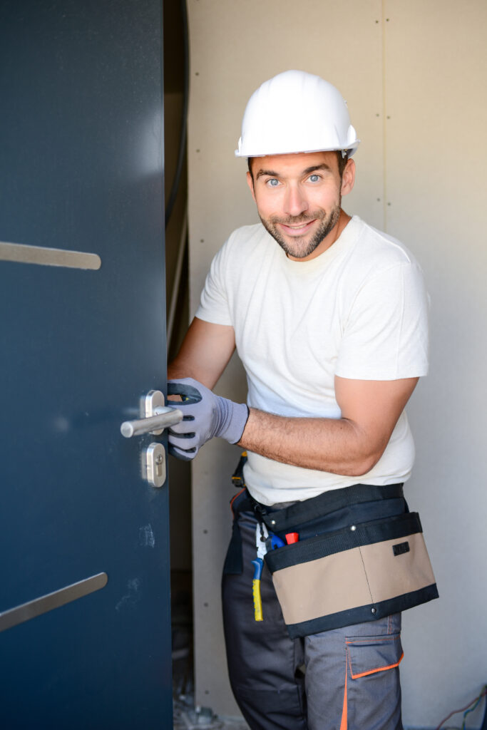 Handsome,Young,Man,Installing,A,Door,In,A,New,House